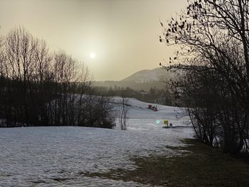 Scenic view of snowcapped mountains against sky during sunset