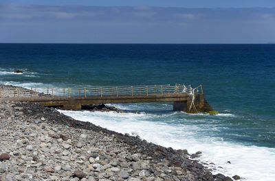 Side view of jetty at calm blue sea