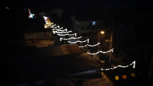 Illuminated christmas lights in city at night