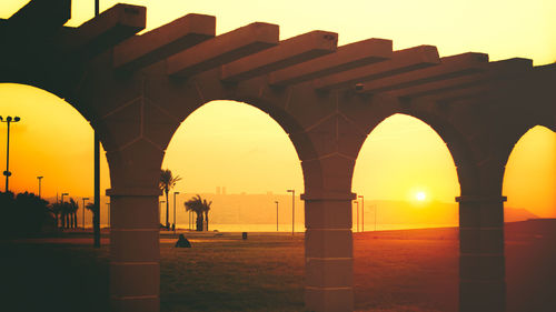 Silhouette of bridge against sunset sky
