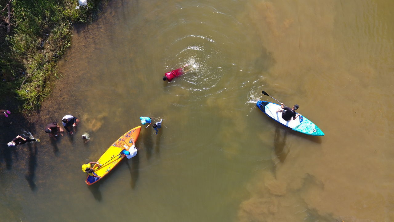 HIGH ANGLE VIEW OF PEOPLE ENJOYING IN SEA