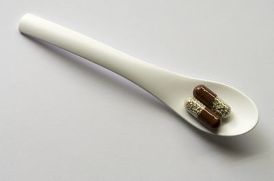 Close-up of spoon on table against white background