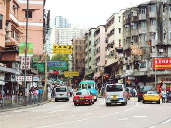 Vehicles on road along buildings