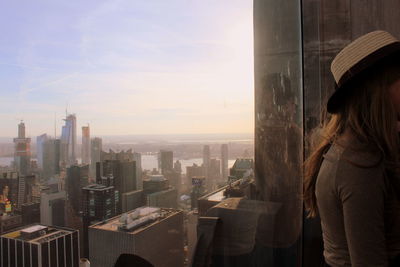 Rear view of woman looking at city buildings