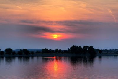 Scenic view of lake against romantic sky at sunset