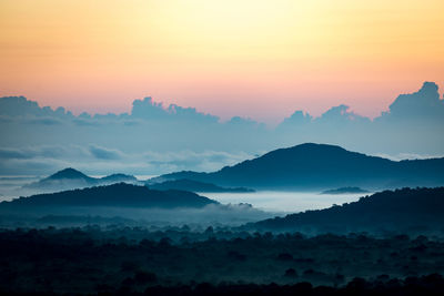 Scenic view of mountains against sky during sunset