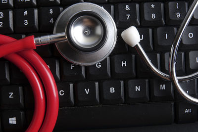 Directly above shot of stethoscope and computer keyboard