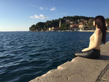 Woman looking at sea in town