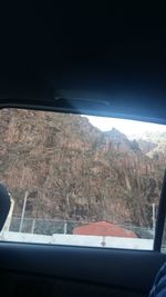 Scenic view of mountains seen through car window