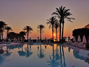 Scenic view of swimming pool against sky during sunset