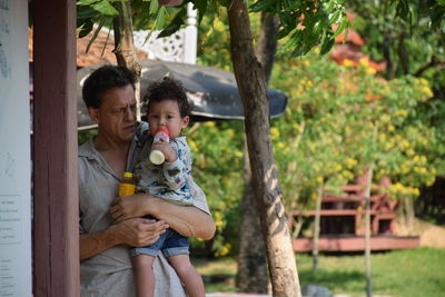 Man carrying boy outdoors