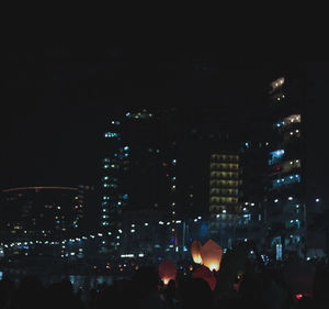 People on illuminated city at night