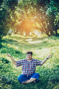 Full length of man sitting on field