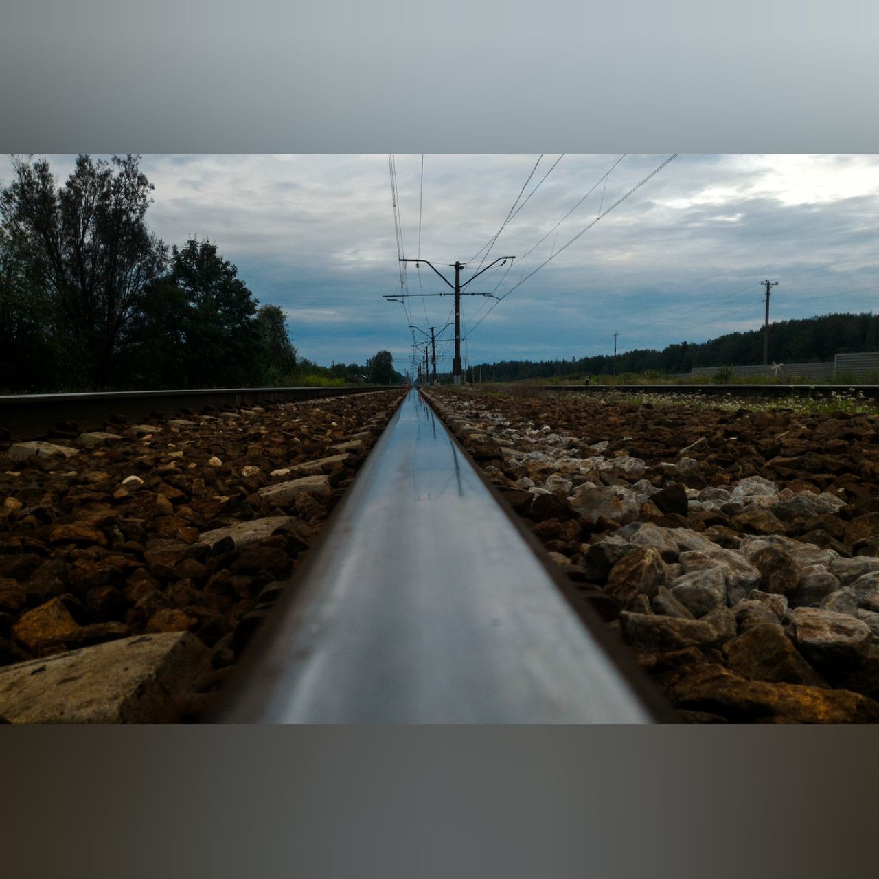 sky, the way forward, diminishing perspective, cloud - sky, vanishing point, railroad track, cloud, landscape, cloudy, day, nature, outdoors, no people, tranquility, tranquil scene, surface level, power supply, weather, overcast, non-urban scene, empty, rural scene, horizon over land