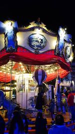 Low angle view of illuminated lanterns hanging at night