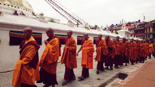 Rear view of people walking in temple