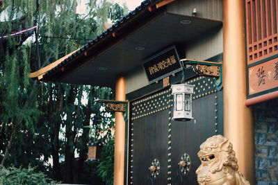 Low angle view of illuminated text by building