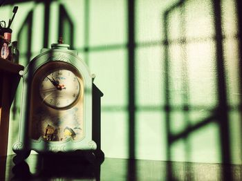 Silhouette window reflected on a clock
