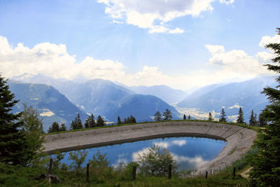 Arch bridge over mountains against sky