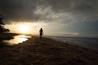 People on beach at sunset