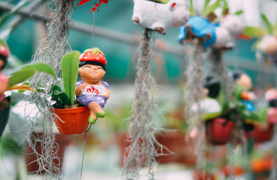 Close-up of figurine hanging outdoors