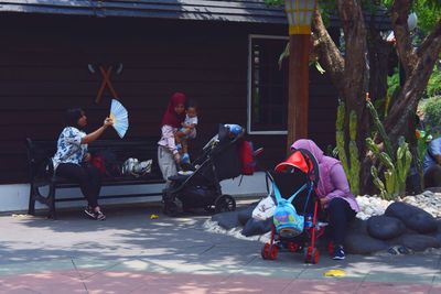 People sitting in front of traditional building