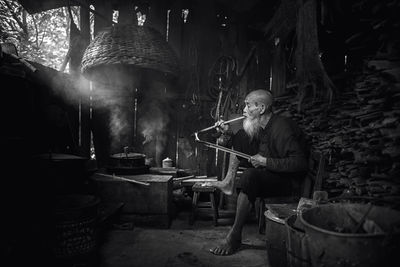 Senior man smoking at home