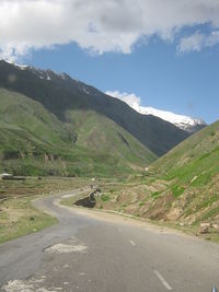 Empty road leading towards mountains