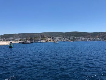 Scenic view of sea against clear blue sky