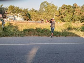 Full length of woman walking on road