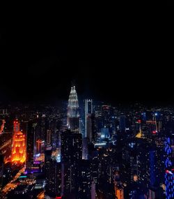 High angle view of illuminated buildings in city at night