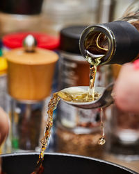 Cropped hand of man preparing food on table