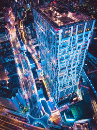 Illuminated modern buildings in city at night