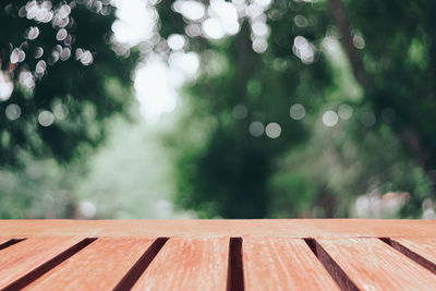 Close-up of raindrops on wooden table