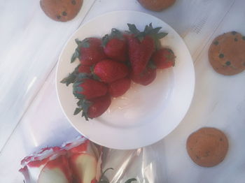 High angle view of strawberries in plate on table