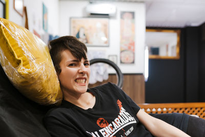 Portrait of smiling boy sitting at home