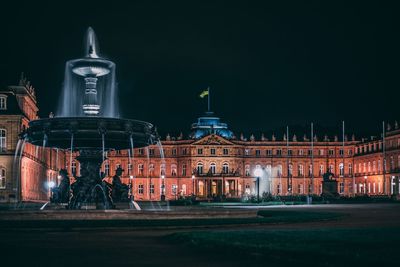 Fountain in city at night