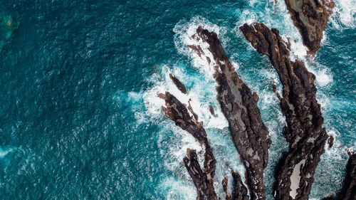 Atlantic ocean coastline, rocks and turquoise waves. madeira, portugal. aerial drone photography