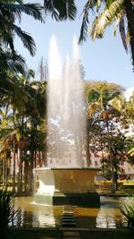 Fountain in park against clear sky