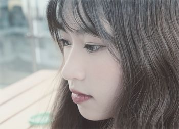 Close-up of thoughtful young woman looking away