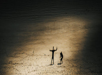 Aerial view of father and daughter at beach