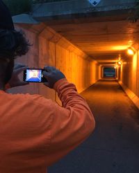 Man photographing illuminated smart phone