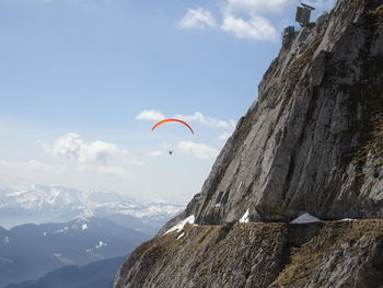 Low angle view of paragliding against sky