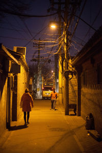 Woman standing in illuminated city at night