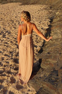 Rear view of woman standing on beach