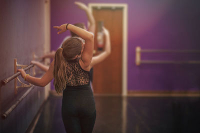 Rear view of girl practicing ballet