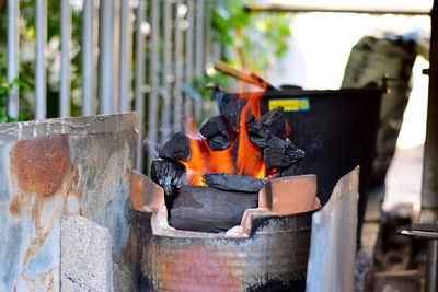 Close-up of burning firewood in container