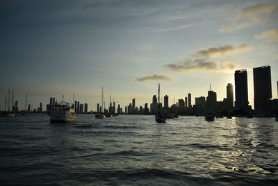 City at waterfront during sunset