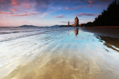 Scenic view of beach against sky during sunset