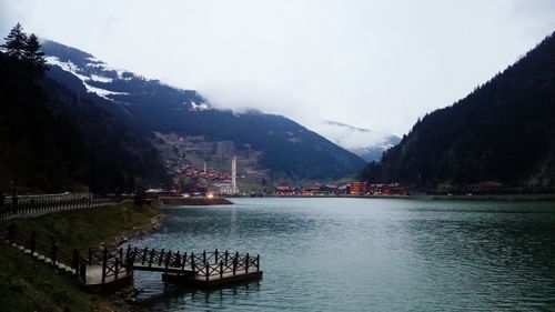 Scenic view of river and mountains against sky